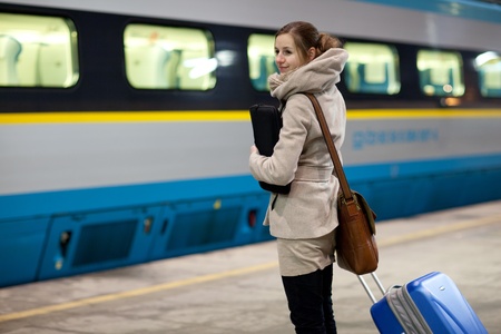 10423355-train-is-coming-young-woman-waiting-for-her-connection-in-a-modern-train-station-shallow-dof