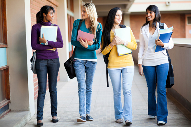 joyful female university student going to lecture hall